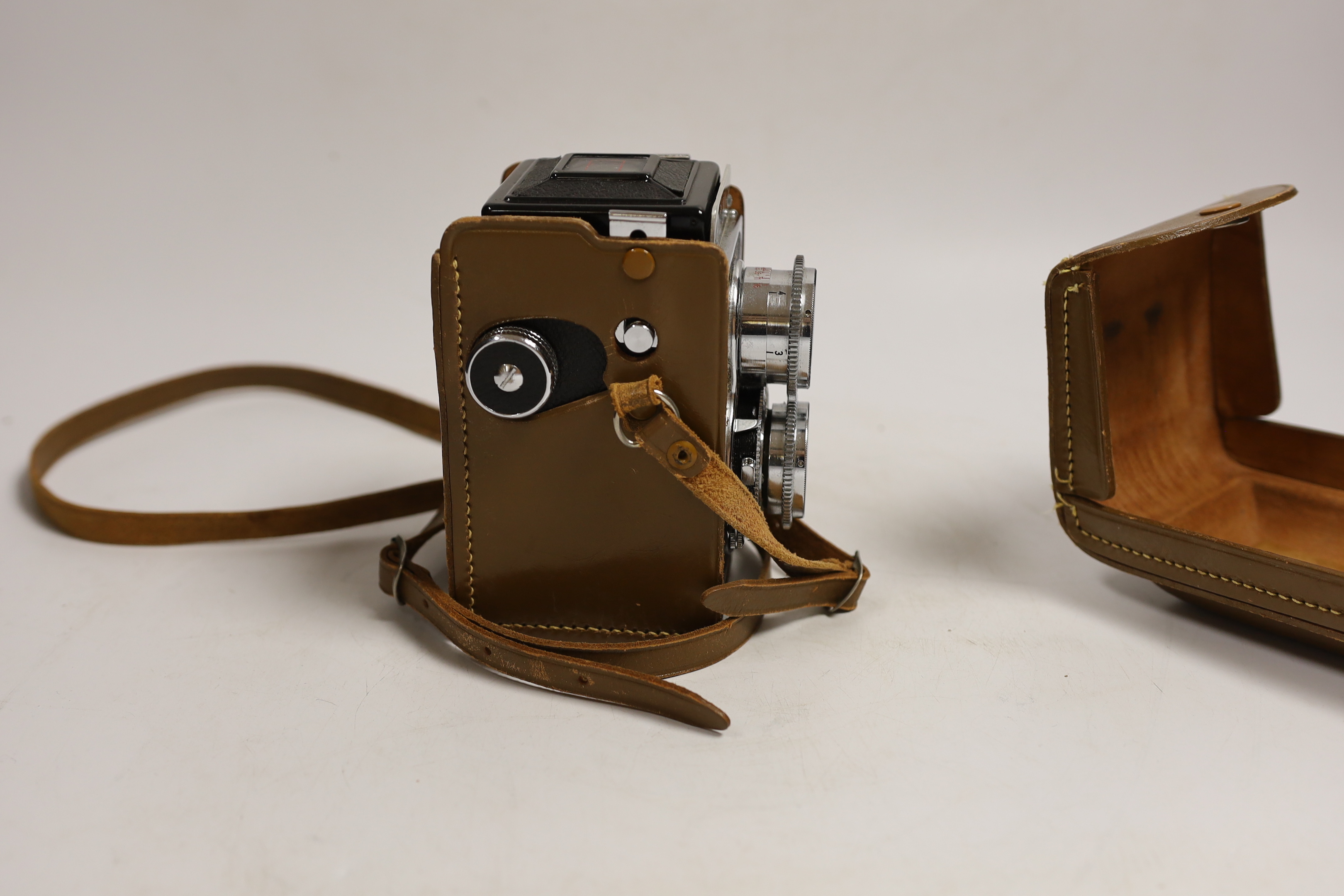A Halina leather-cased camera, camera approx 14cm high